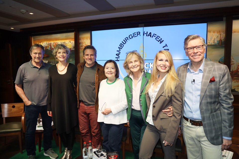 Teilnehmer des 14. Hamburger Hafen Talks (v.l. Herma Koehn, René Steinke, Anna Schäfer, Doris Kunstmann, Thorsten Laussch, Alexandra Rotmann und Helmut Zierl) auf der Bühne nebeneinander stehend und lächelnd.
